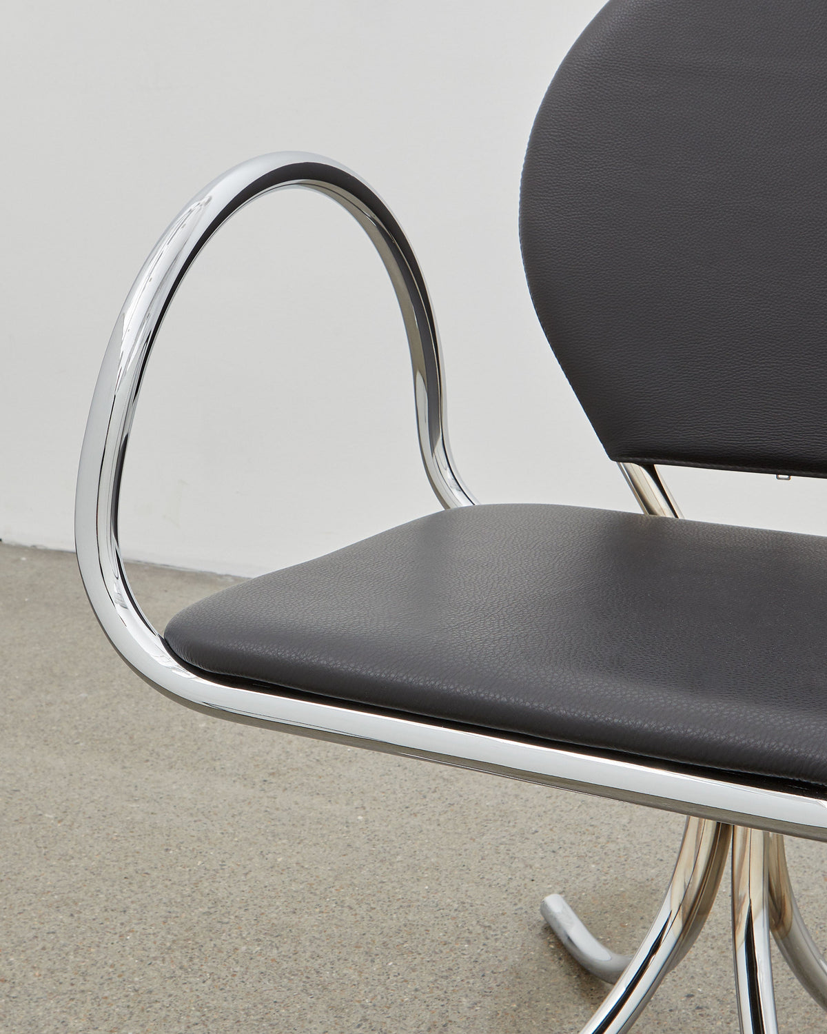 PH Arm Chair by Poul Henningsen, Danish design classic (1932),A armchair with a black cushioned seat and backrest, and chrome steel tube frame.