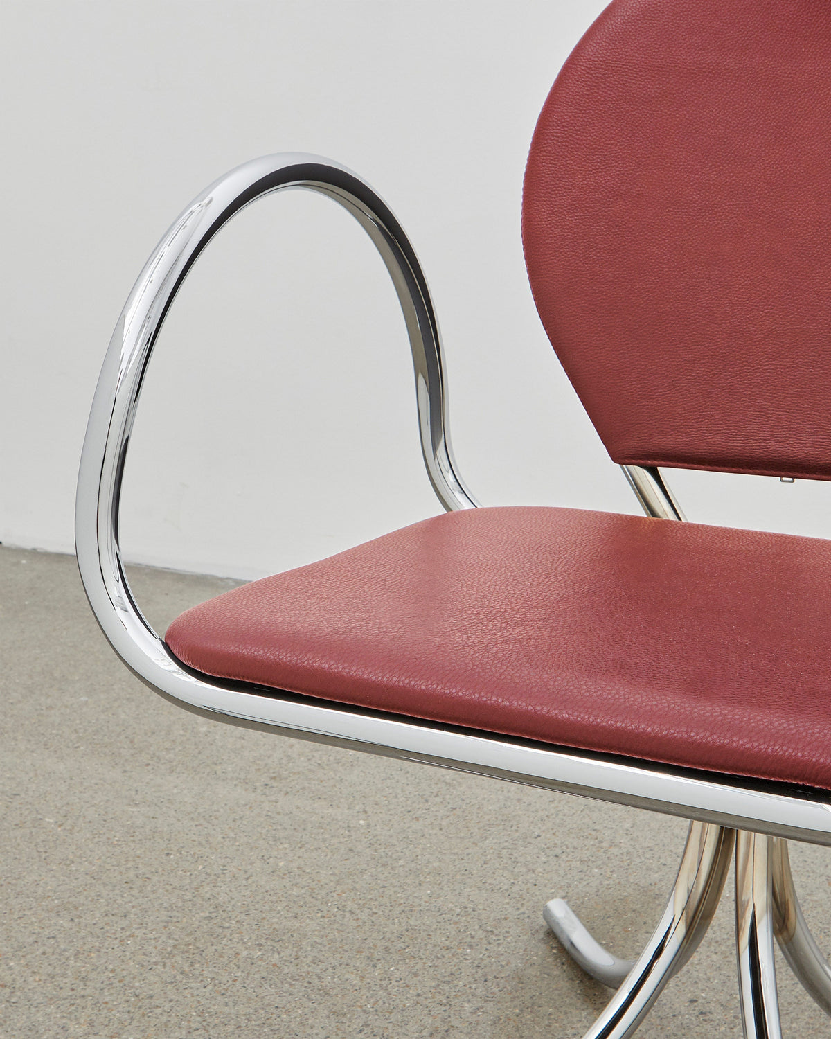 PH Arm Chair by Poul Henningsen, Danish design classic (1932),A armchair with a red cushioned seat and backrest, and chrome steel tube frame.