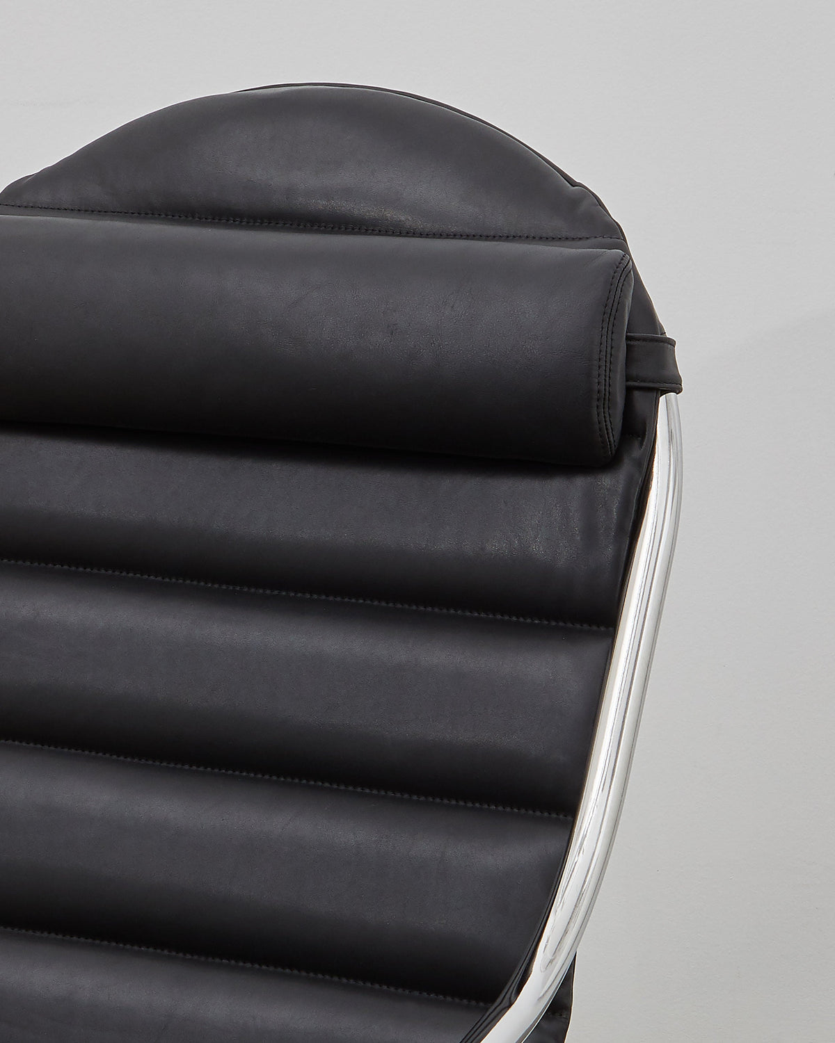 A black upholstered PH lounge chair with a chromed steel tube frame, designed by Poul Henningsen.