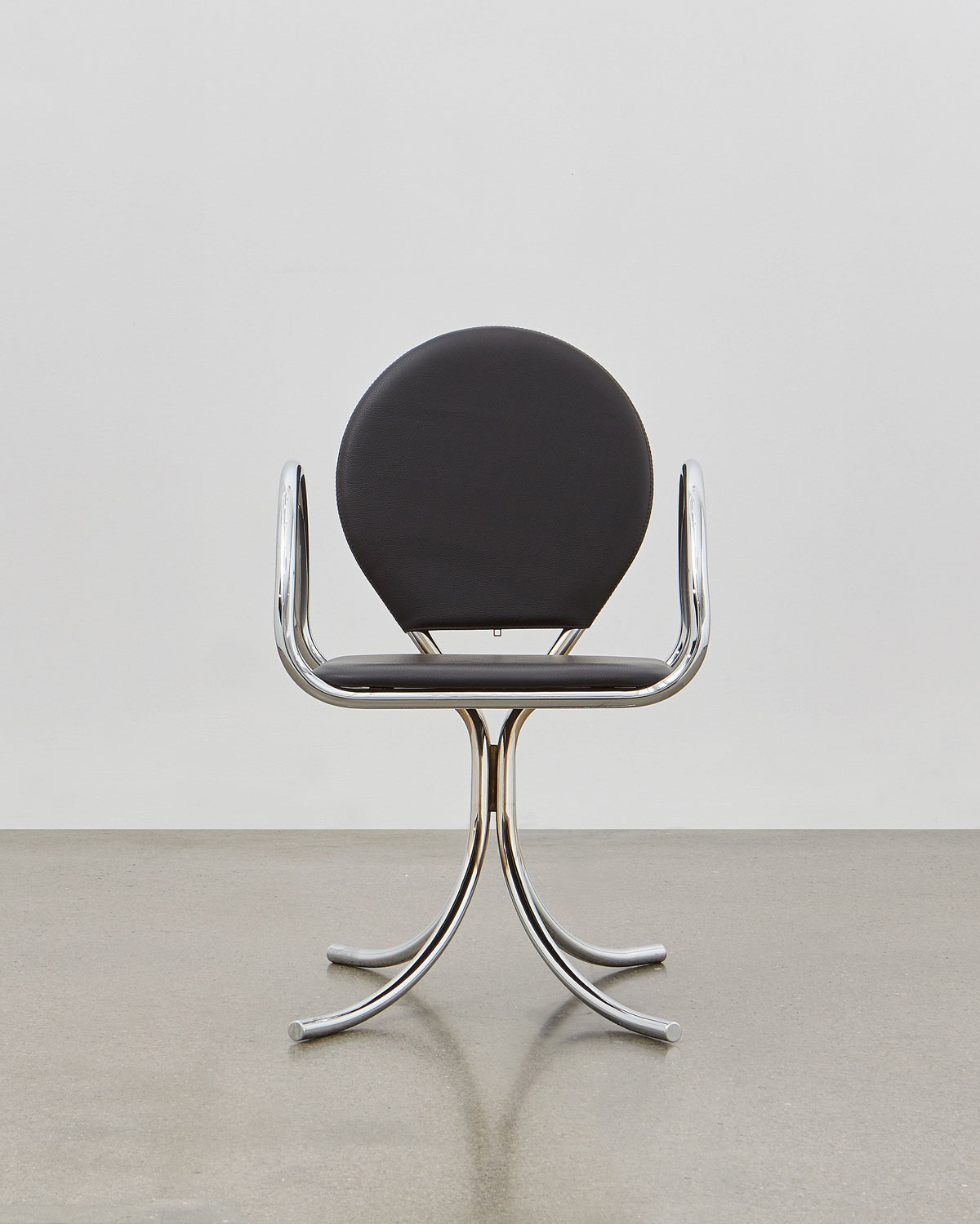 PH Arm Chair by Poul Henningsen, Danish design classic (1932),A armchair with a black cushioned seat and backrest, and chrome steel tube frame.