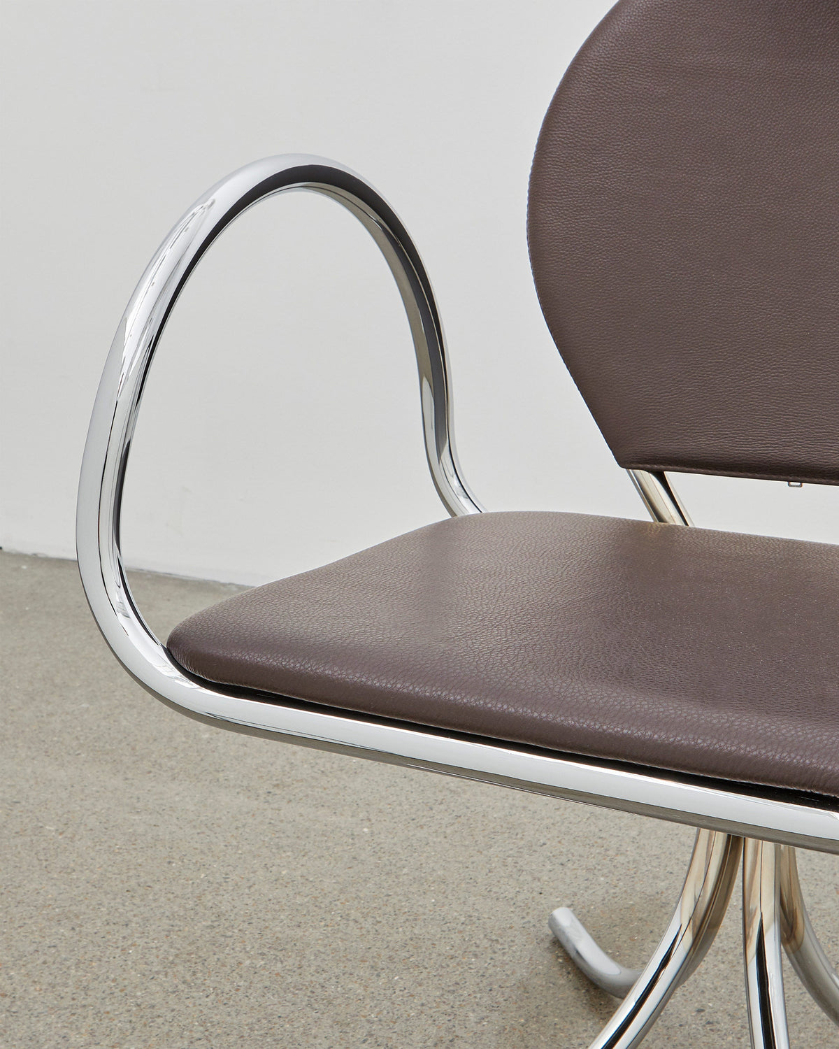PH Arm Chair by Poul Henningsen, Danish design classic (1932),A armchair with a brown cushioned seat and backrest, and chrome steel tube frame.