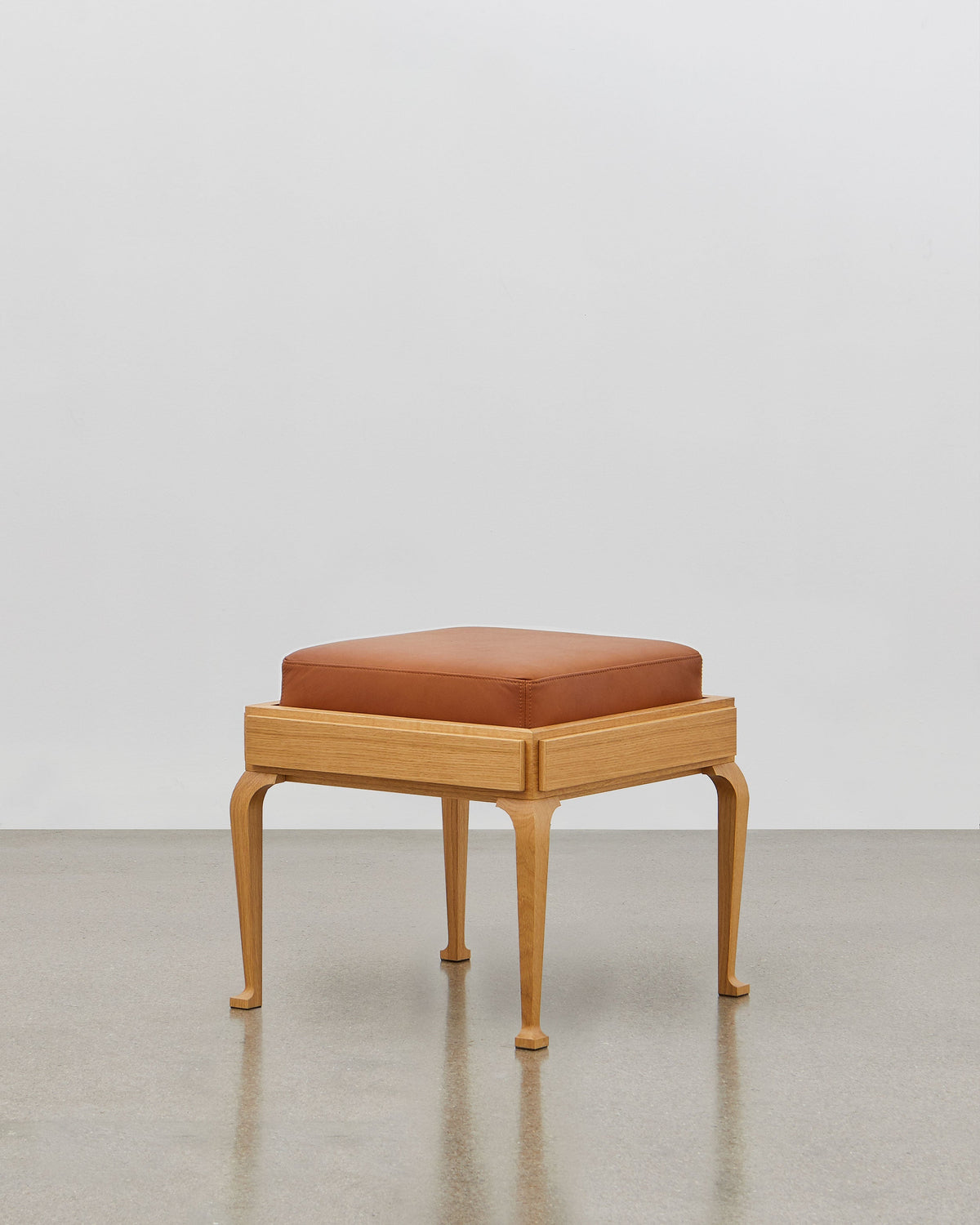 PH Stool by Poul Henningsen, Danish design classic (1920) A walnut upholstered stool standing on four angled wooden legs.