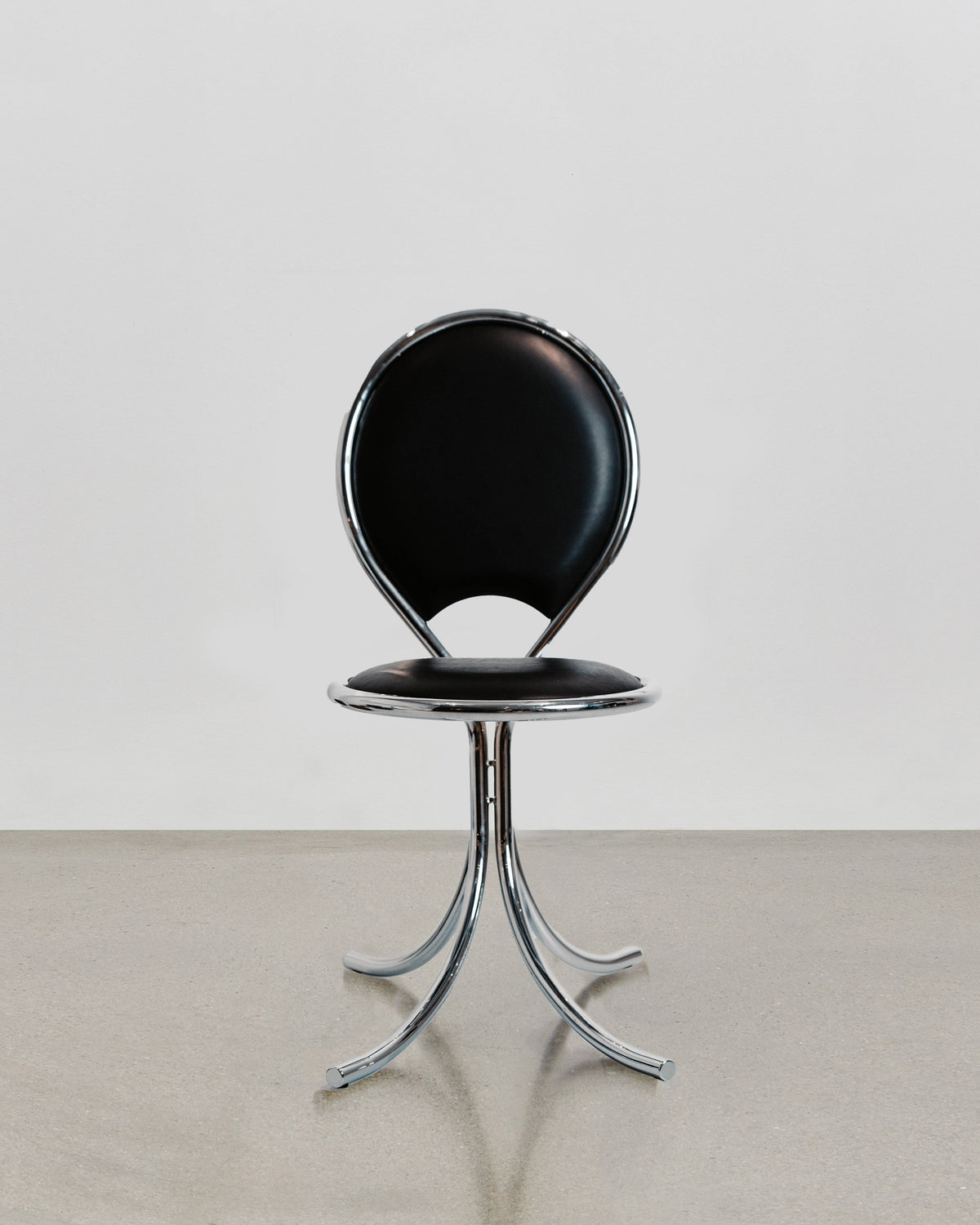 PH Steel Chair by Poul Henningsen, Danish design classic (1932) a steel chair with a black cushioned seat and backrest and chrome steel tube frame